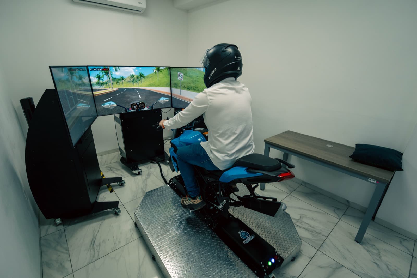 Applicant taking the motorcycle license test on an APEX simulator in Guanajuato